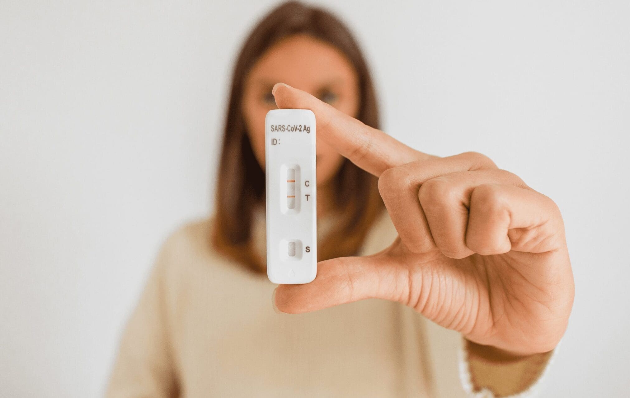 A woman showing a Covid test