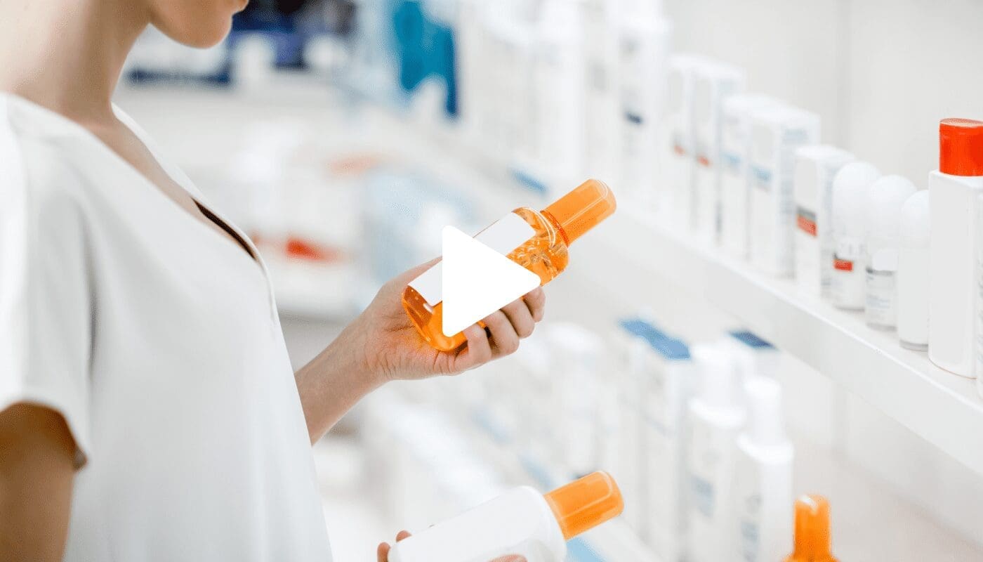 A woman holds an orange bottle