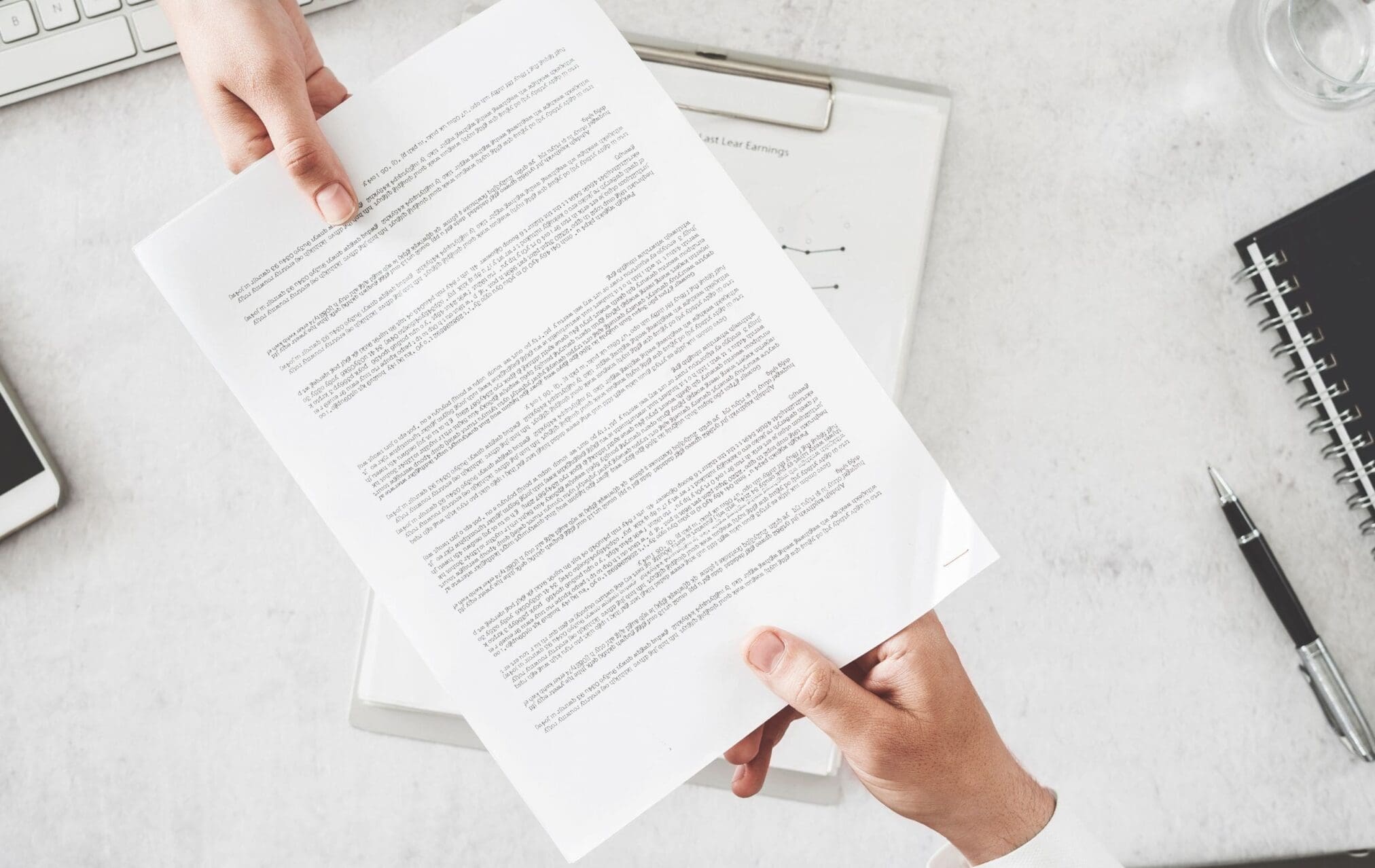 Two hands holding a paper