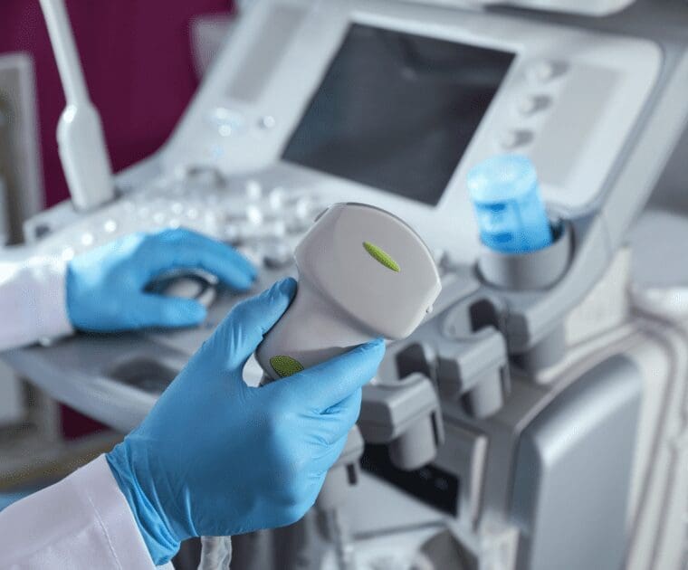 A person utilizes an ultrasound machine