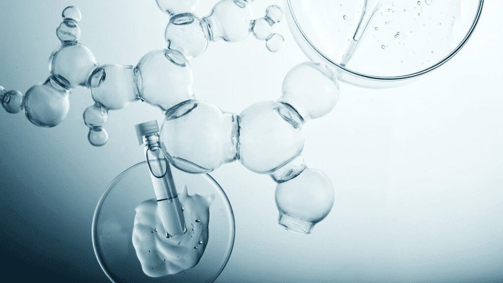 Transparent molecular structure overlaid with a glass vial, petri dish containing cream, and a pipette in a clear liquid, representing cosmetic science and ingredient formulation.