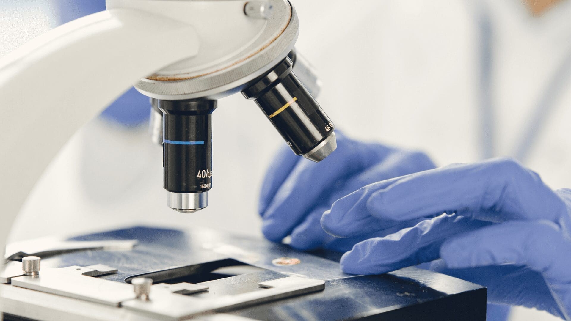 Scientist using a microscope to examine a sample