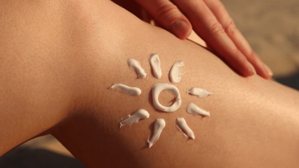 Close-up of sunscreen lotion drawn in the shape of a sun on a person's skin