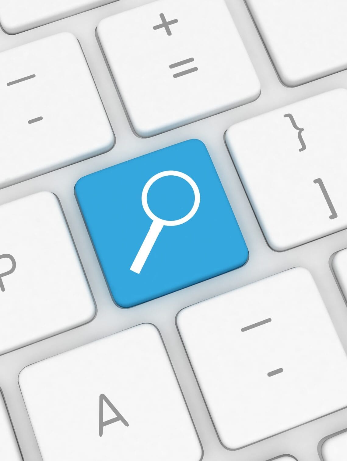 Close-up of a keyboard with a highlighted search key featuring a magnifying glass icon.