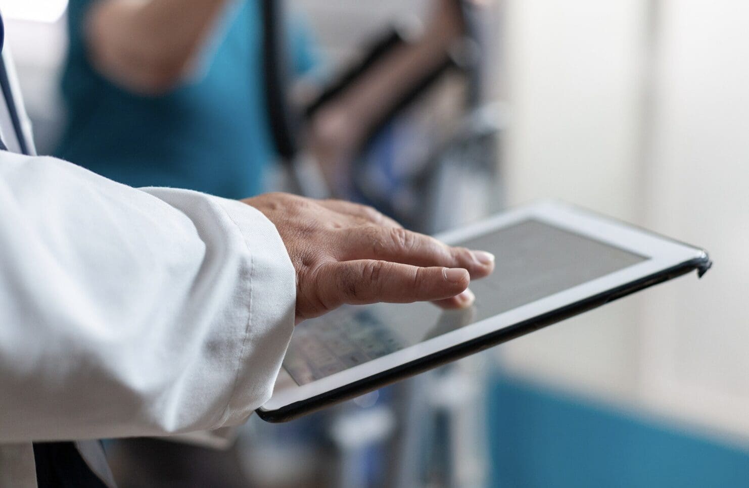 close up of a doctor working on an ipad